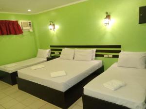 Postel nebo postele na pokoji v ubytování Hotel Benjamin Naval