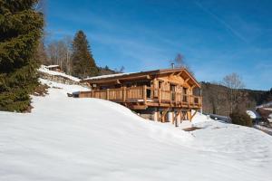 a wooden cabin in the snow with a snow mound at L'instant chalet Lodge 17 in Gérardmer