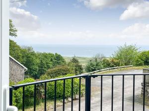 a view of the ocean from the balcony of a house at The Stables in Penally