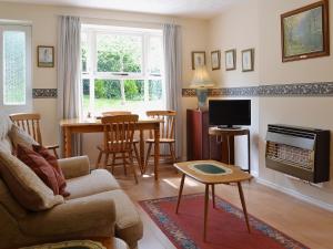 a living room with a couch and a table at Mallards in Wells next the Sea