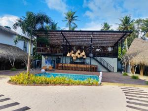 a resort with a swimming pool and a building at Shima Guni Beach Club Hotel in Matara