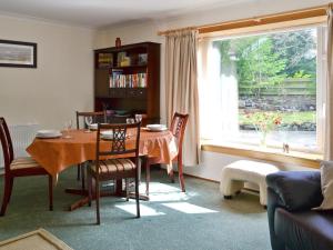 a living room with a table and a window at Kilmuir in Selkirk
