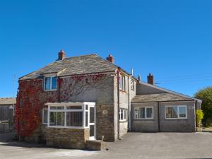 an old brick house with a lot of windows at Haycombe Cottage in Camelford