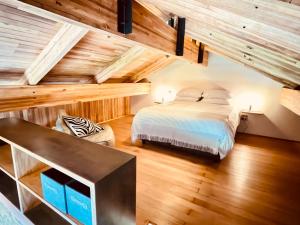 a bedroom with a bed in a room with wooden ceilings at Swiss Chalet Clarens in Clarens