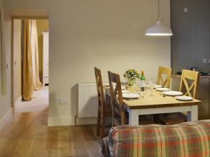 a dining room with a table with chairs and a dining room at The Cottage in Bankfoot