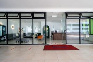 a living room with glass doors and a red rug at Windmill Premier Suites Genting Highlands in Genting Highlands