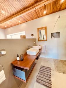 a bathroom with a sink and a mirror at Swiss Chalet Clarens in Clarens