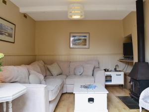 a living room with a couch and a table at The Garden Cottage in Wrafton
