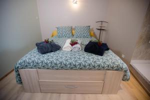 a bedroom with a bed with two dolls on it at ODYSSEE l'expérience commence ici JACUZZI in Saint-Jean-Bonnefonds