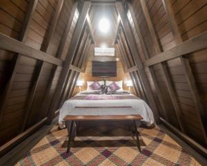 a bedroom with a bed in a wooden room at Rumah Kayu Tatiya Villa in Ungasan