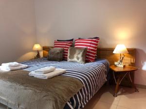 a bedroom with a bed with towels on it at Le Clos du Square - climatisé in Rochefort