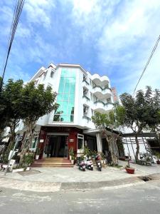 a large building with motorcycles parked in front of it at MILAND HOTEL in Can Tho