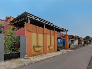 un edificio con paneles coloridos en el lateral de una calle en OYO 92123 Chikam House Syariah, en Kediri