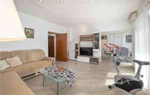 a living room with a couch and a vacuum at Awesome Home In Crikvenica With House Sea View in Crikvenica