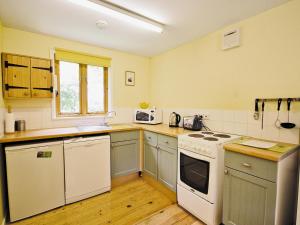 een keuken met witte apparatuur en een witte kookplaat bij Briar Cottage - E5335 in Redisham