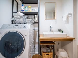 a laundry room with a washing machine and a sink at Rakuten STAY HOUSE x WILL STYLE Matsue 102 in Matsue