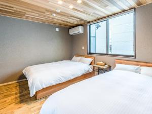 松江市にあるRakuten STAY HOUSE x WILL STYLE 松江 102のベッドルーム1室(ベッド2台、窓付)