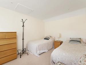 ソーントン・デールにあるShaws Cottageのベッドルーム1室(ベッド2台、ドレッサー付)
