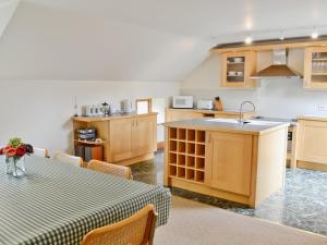 a kitchen with a table and a sink at Till Cottage in Milfield