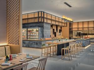 a rendering of a restaurant with tables and chairs at Holiday Inn & Suites Kunshan Huaqiao, an IHG Hotel - F1 Racing Preferred Hotel in Kunshan