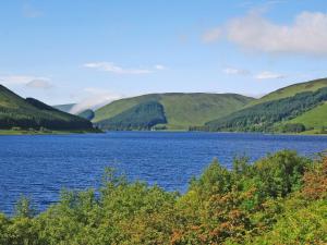 a view of a loch in the hills at Roseburn Cottage in Moffat