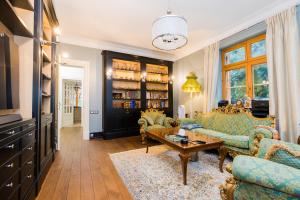 a living room with two couches and a table at Stately Home in Magdalenka, nr Warsaw in Magdalenka