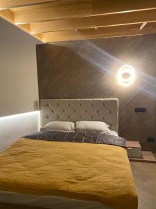 a bedroom with a large bed with a yellow blanket at Teleferic9 in Predeal