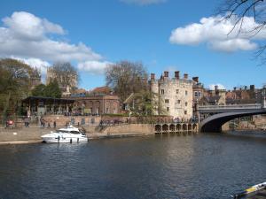 a boat in a river in front of a bridge at City 3 in York