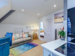 a living room with a couch and a table at Beau Rivage in Goodrington