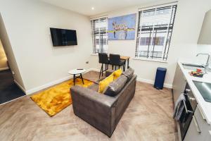 a living room with a couch and a table at The Stay Company, Whitefriars House in Nottingham