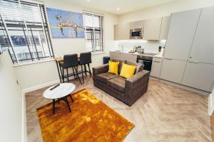 a living room with a couch and a table at The Stay Company, Whitefriars House in Nottingham