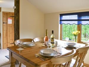 a dining room table with two bottles of wine on it at Butlers Barn in Darsham