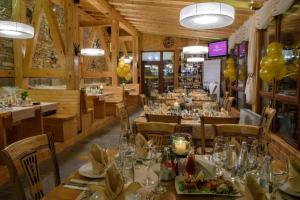 a dining room with tables and chairs and balloons at ЗАМЪКА 1 in Pamporovo