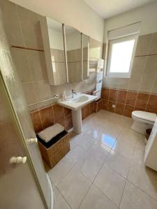 a bathroom with a sink and a toilet and a mirror at Port de Pornic. Vue mer. Sea view. 4 rooms. in Pornic