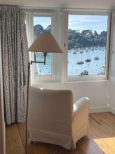 a living room with a chair and a window at Port de Pornic. Vue mer. Sea view. 4 rooms. in Pornic