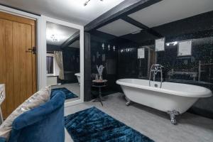 a large bathroom with a tub and a sink at The Ancient Unicorn in Barnard Castle
