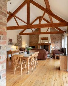 a living room with a wooden table and chairs at Wheelhouse Cottage . A brick-built barn conversion in Thirsk