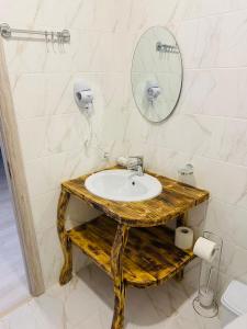 a bathroom with a sink and a mirror at DACHA на Магурі in Pilipets +61 photos