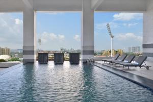 a swimming pool on the roof of a building at Courtyard by Marriott Navi Mumbai in Navi Mumbai