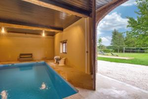 an indoor swimming pool in a house with a patio at Crazy Villa Ricardière 89 - Indoor heated pool - Basket - 2h Paris - 30p in Villefranche-Saint-Phal