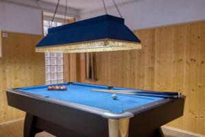 a pool table in a room with a chandelier at Crazy Villa Margotterie 58 - Heated pool - 2h from Paris - 30p in La Celle-sur-Loire