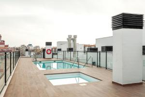 a balcony with a swimming pool on top of a building at Tejares Sevilla Luxury Penthouse en Triana - gran terraza, piscina & parking privados in Seville
