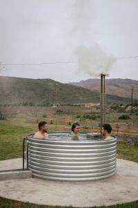 a group of men in a hot tub with smoke at Blue Cow Barn - Boutique Farm in Barrydale