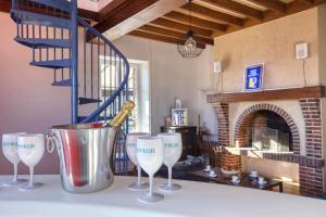 a table with three wine glasses and a bucket at Crazy Villa Chalonie 28 - Heated pool - Soccer - Basket - 2h Paris - 30p in Happonvilliers