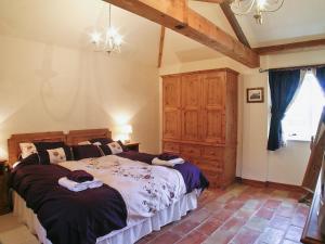 a bedroom with a large bed in a room at The Byre - Ijw in Brigham