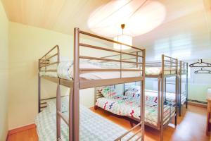 two bunk beds in a room with a ceiling at Crazy Villa Radar 89 - Heated pool - Multisports field - 2h Paris - 30p in Saint-Cyr-les-Colons +13 photos