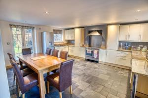 a kitchen with a wooden table and chairs at Pass the Keys Family home in the countryside in Lincoln