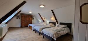 a room with three beds and a staircase at La Ferme de L'Etang in Trélévern