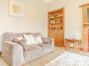 a living room with a couch and a table at Blair Terrace in Portpatrick