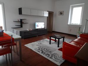 a living room with a couch and a tv at Domus Flavia in Mantova